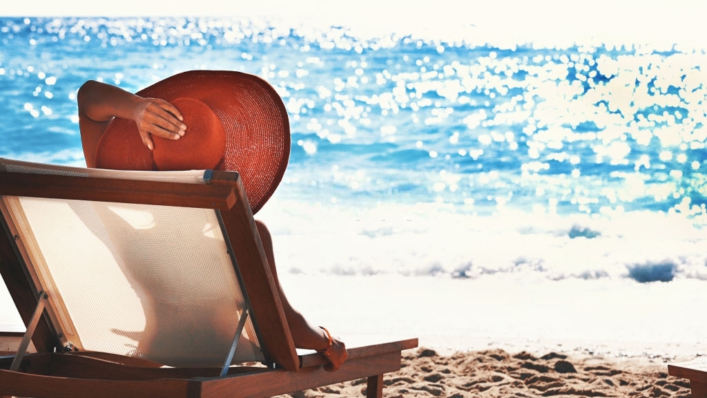 girl lounging on beach in chair
